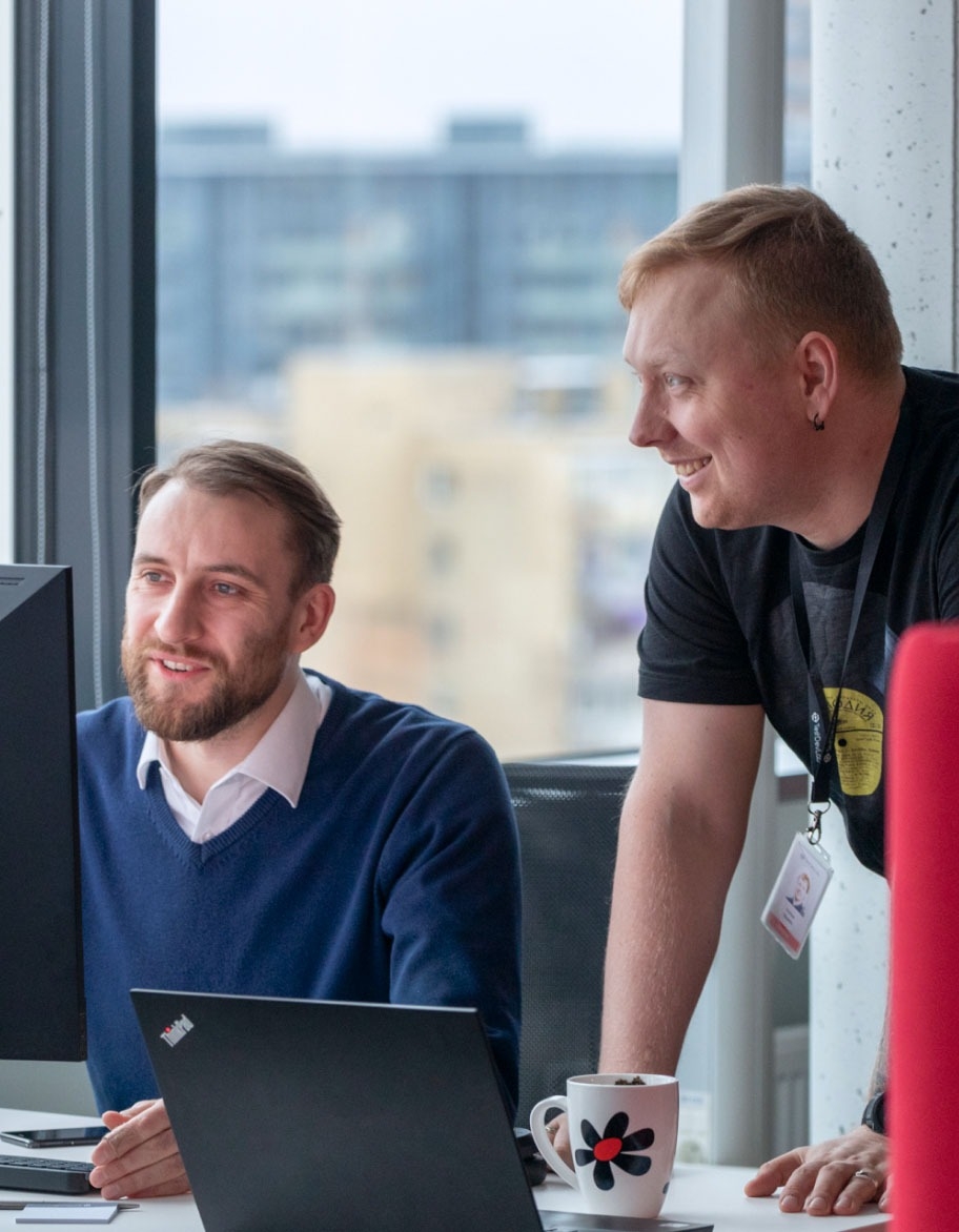 Two experts looking at the monitor and checking.